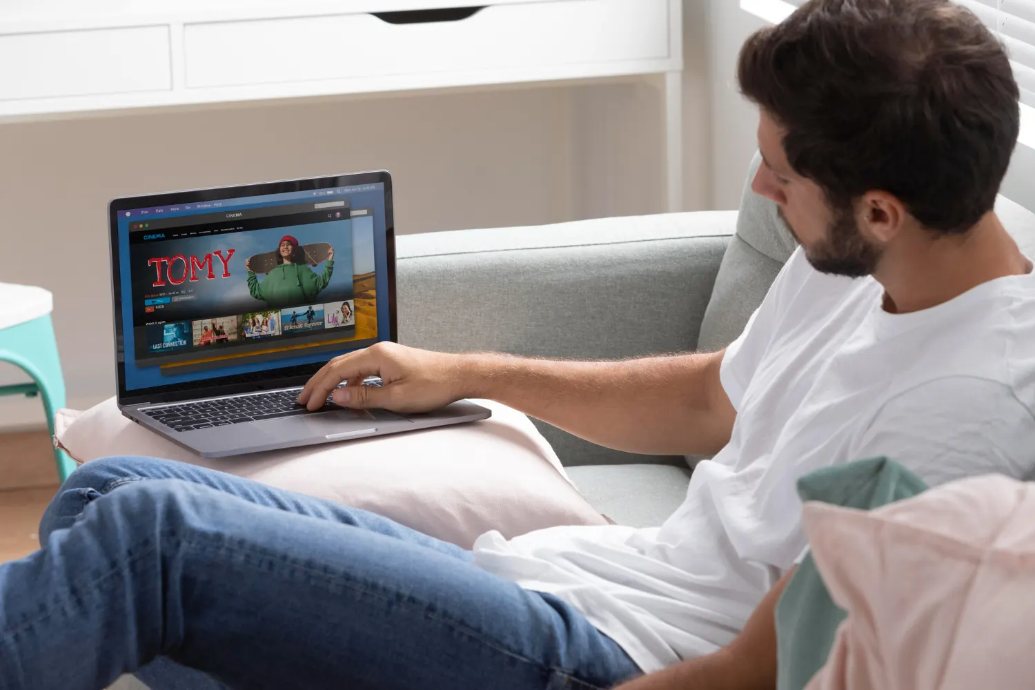 Man testing Nordic IPTV on a tablet at home on the sofa