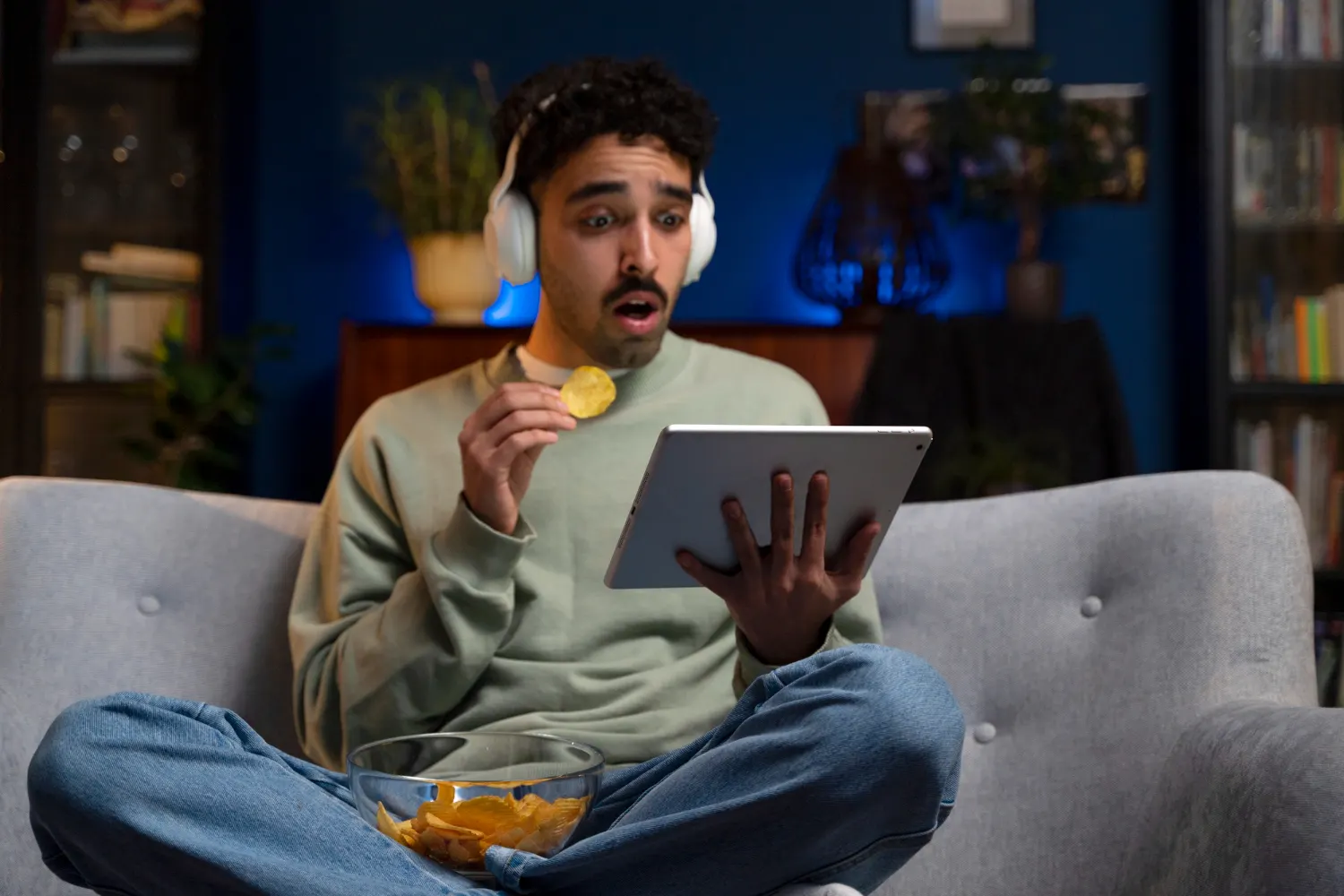 Man watching IPTV on a tablet at home on the sofa